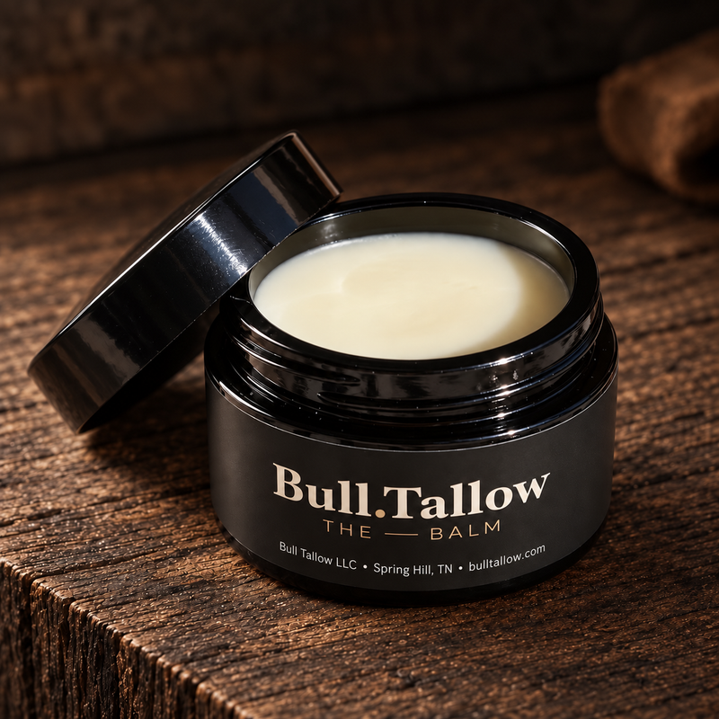 Bull Tallow The Balm in an open black jar on rustic wood, with the Bull Tallow LLC, Spring Hill, TN label